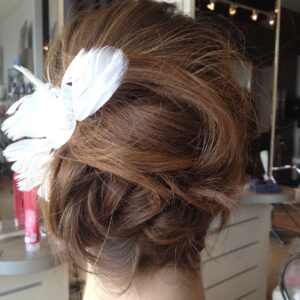 wedding updo with feather fortelli oakville